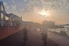 Cyclists cycling by the Staiths at sunset